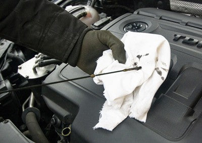Oily rag and car oil dipstick